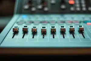 Produttore musicale al lavoro in studio di registrazione con mixer e attrezzature professionali