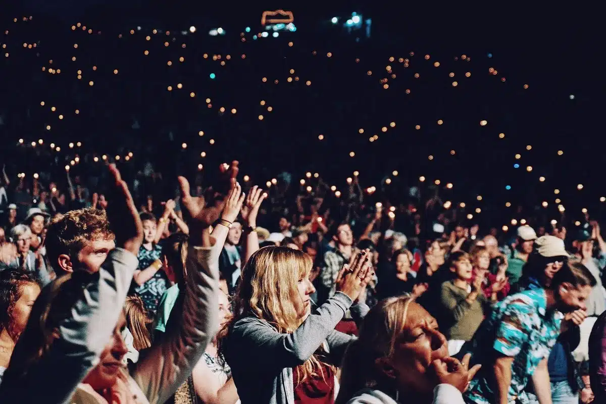 Pubblico entusiasta che applaude e canta durante una performance live